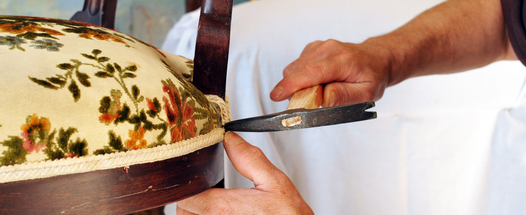 Upholsterer lining the seat of a chair